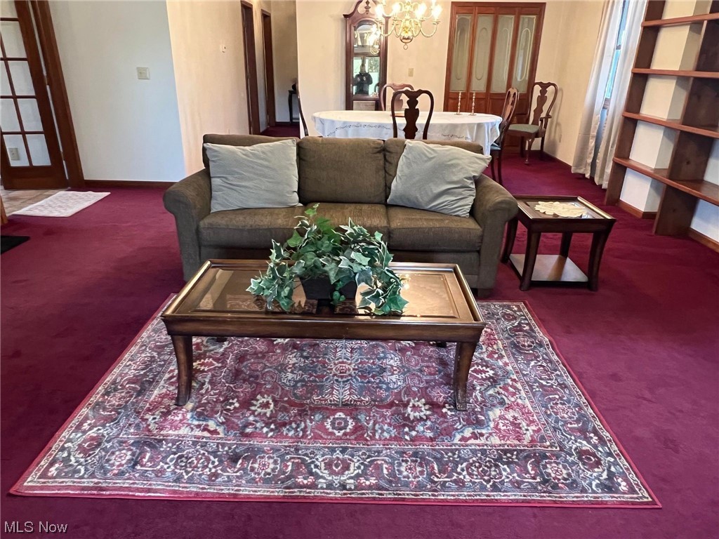 36555 Flat Rock Road Barnesville, OH 43713 - Photo 5 of 35 Carpeted living room with a chandelier