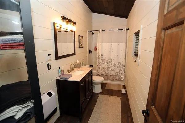 a bathroom with a sink a mirror and a shower