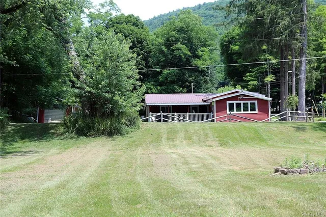 a view of a house with a yard and sitting area