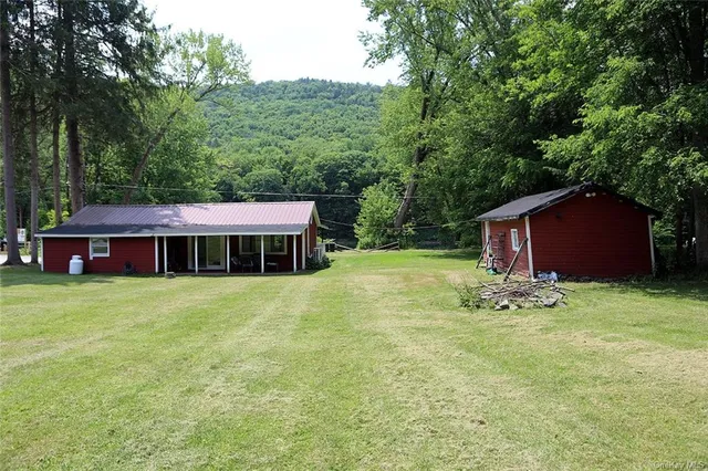 a backyard of a house with yard and trampoline