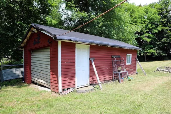 a view of a lake with a yard and large trees