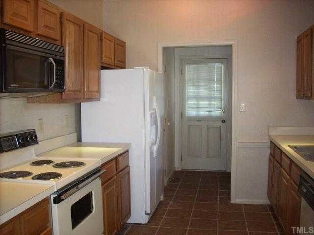 3025 Chippendale Road Raleigh, NC 27604 - Photo 5 of 12 a kitchen with a stove and a microwave