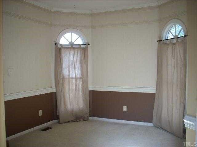 3025 Chippendale Road Raleigh, NC 27604 - Photo 7 of 12 an empty room with chandelier fan and closet