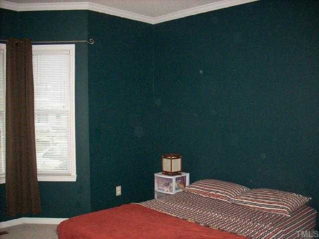 3025 Chippendale Road Raleigh, NC 27604 - Photo 8 of 12 a bedroom with a bed and a window