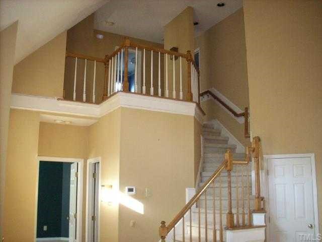 3025 Chippendale Road Raleigh, NC 27604 - Photo 10 of 12 a view of staircase with lots of frames on wall and windows