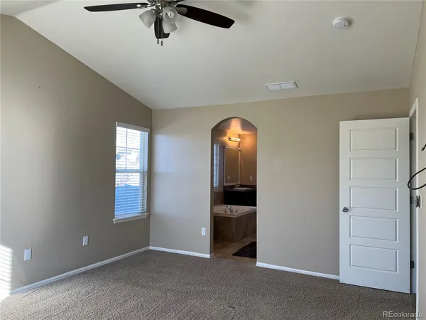 an empty room with windows and closet