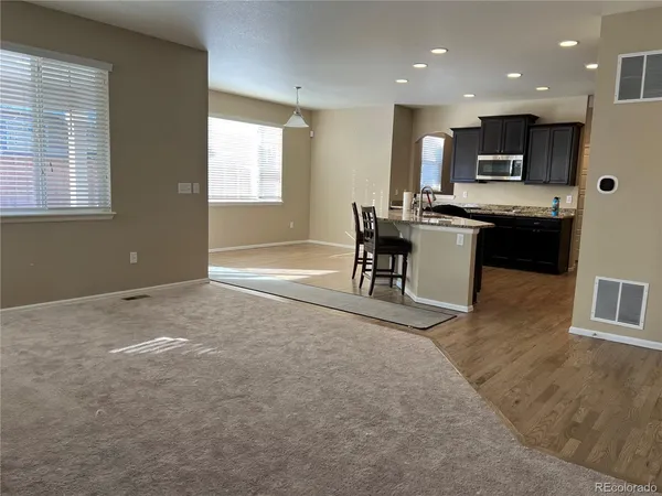a view of kitchen with microwave and cabinets