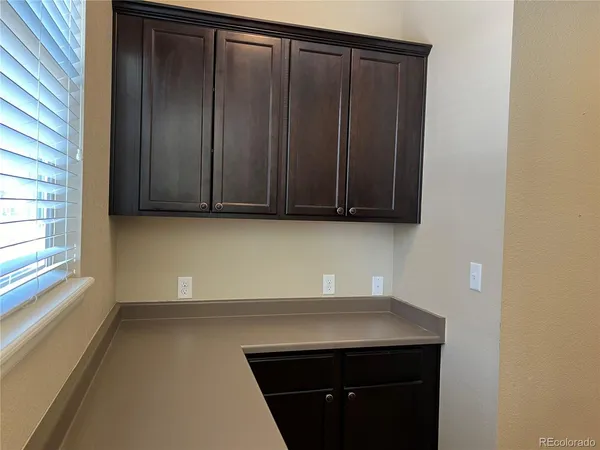 a view of storage area and wooden floor