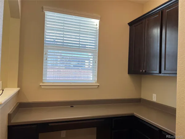 a view of a room that has a window and cabinets
