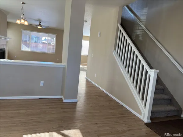 an entryway and a hallway with wooden floor