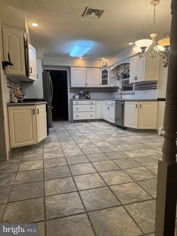 a bed sitting in a bedroom and mirror