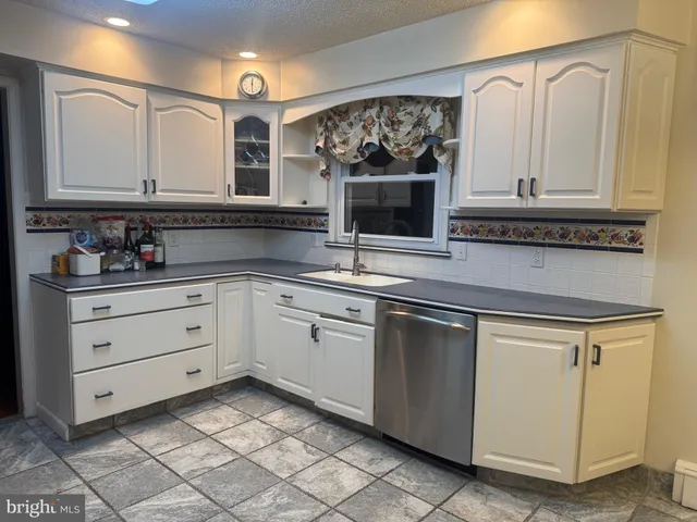a view of an empty room with wooden floor and stairs