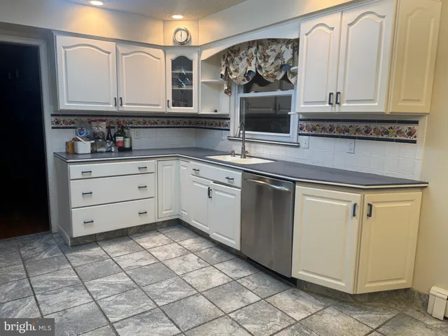 an empty room with wooden floor and a window