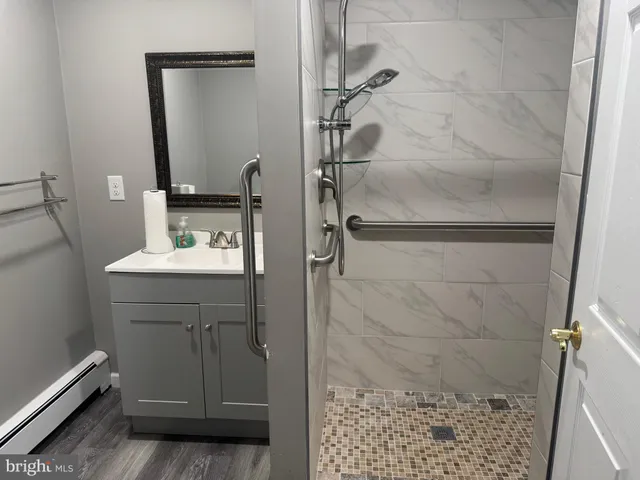 a bathroom with a granite countertop sink a toilet a mirror and vanity
