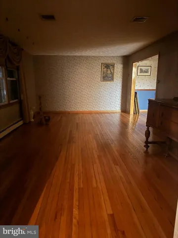 a large kitchen with granite countertop a stove a sink and a refrigerator
