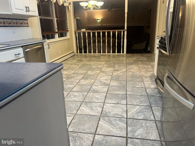 a kitchen with stainless steel appliances granite countertop a refrigerator stove and sink