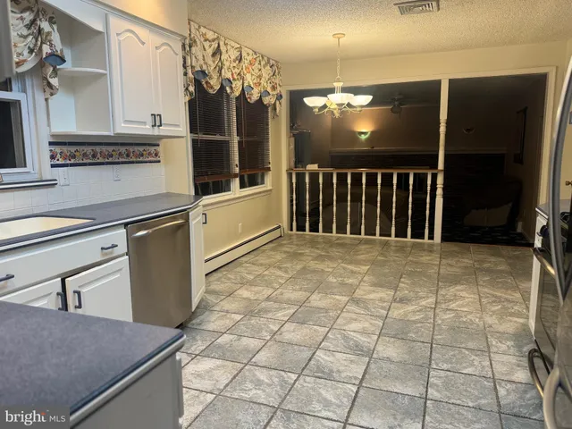 a kitchen with stainless steel appliances granite countertop a sink and a microwave