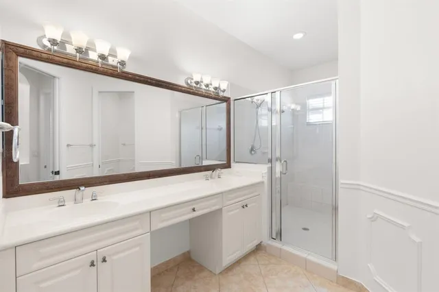 a bathroom with a shower sink double and mirror