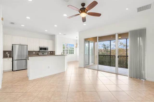 a view of a kitchen with refrigerator and an floor to ceiling window