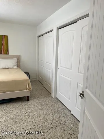 a bedroom with a bed and a rug
