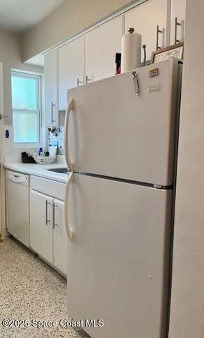 a white house with sink and dishwasher