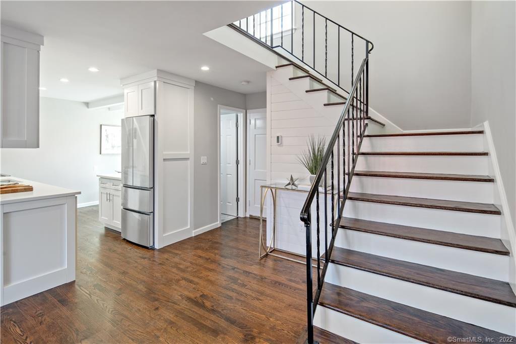 a view of entryway with wooden floor and stairs