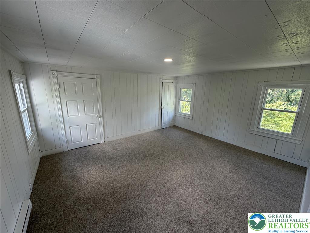 5720 Memorial Road Germansville, PA 18053 - Photo 13 of 29 A well-lit bedroom provides a cozy retreat with soft carpeting and natural light.