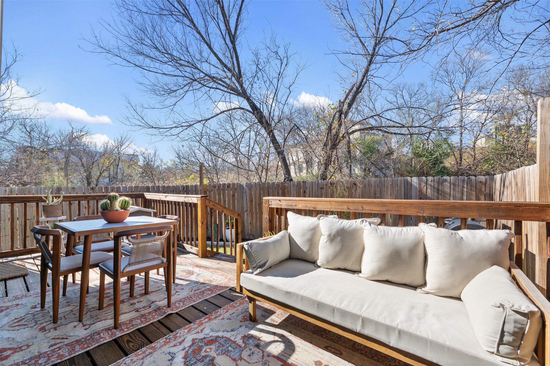 1616 Webberville Road, Unit A Austin, TX 78721 - Photo 25 of 35 Wooden deck with outdoor dining space, a fenced backyard, and an outdoor living space