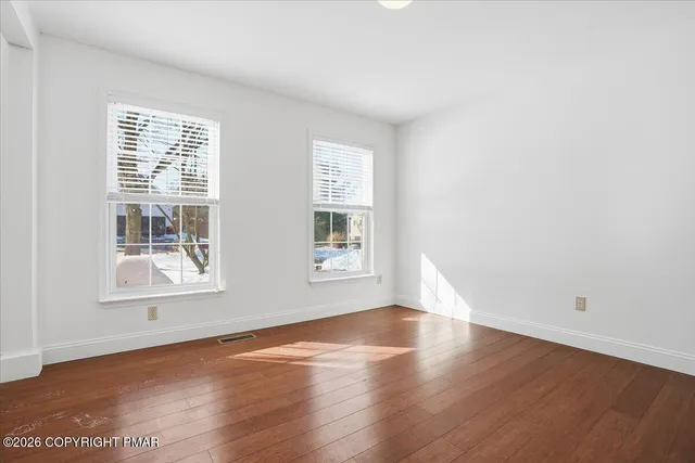 a view of a room with wooden walls and windows