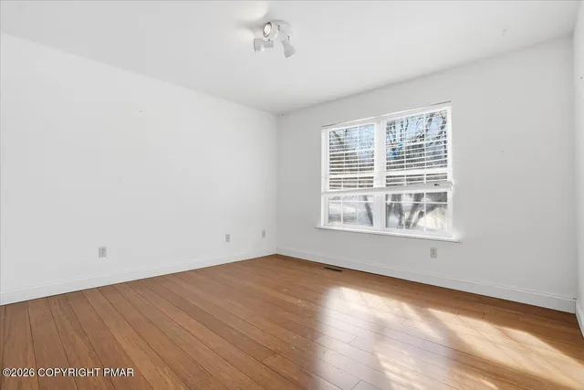 a view of a house with snow on the road