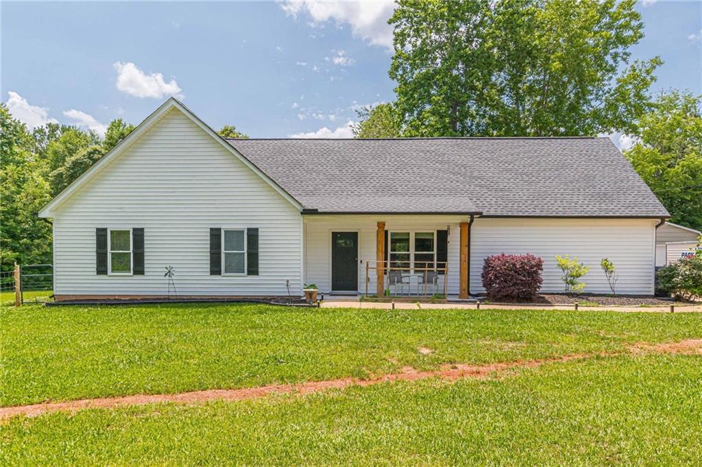 a front view of house with yard and green space