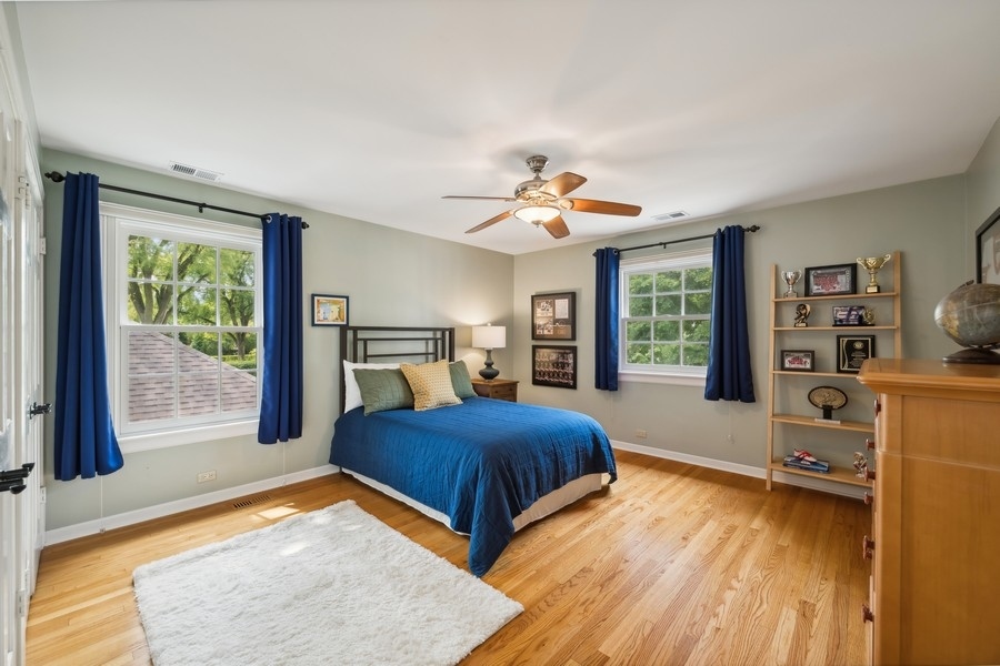 930 Pontiac Road Wilmette, IL 60091 - Photo 23 of 45 a bedroom with a bed and large window with chair