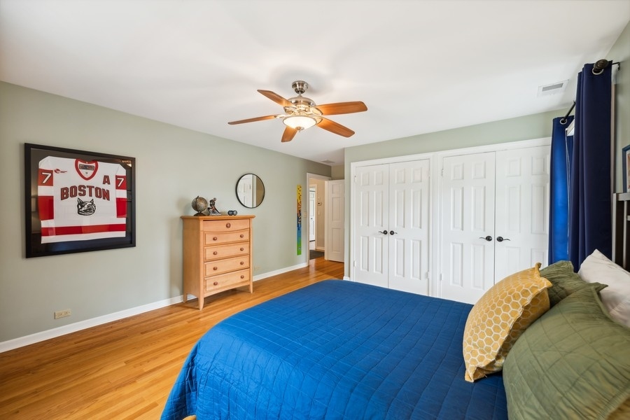 930 Pontiac Road Wilmette, IL 60091 - Photo 24 of 45 a bedroom with a bed and a chandelier