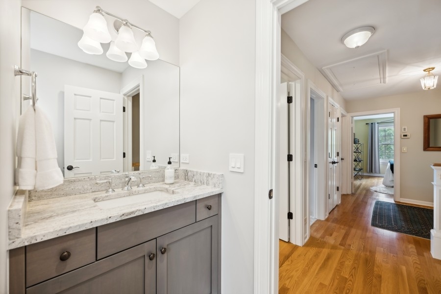 930 Pontiac Road Wilmette, IL 60091 - Photo 28 of 45 a spacious bathroom with a double vanity sink and a mirror