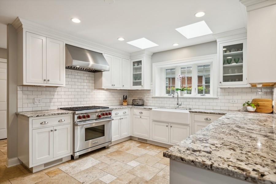 930 Pontiac Road Wilmette, IL 60091 - Photo 8 of 45 a kitchen with a stove sink and cabinets