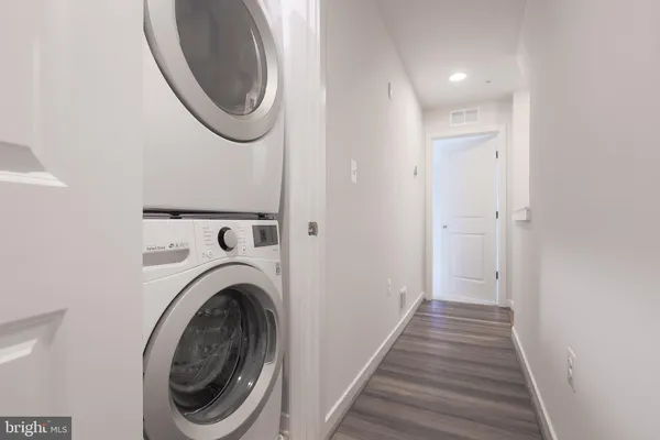a view of a hallway with washer and dryer