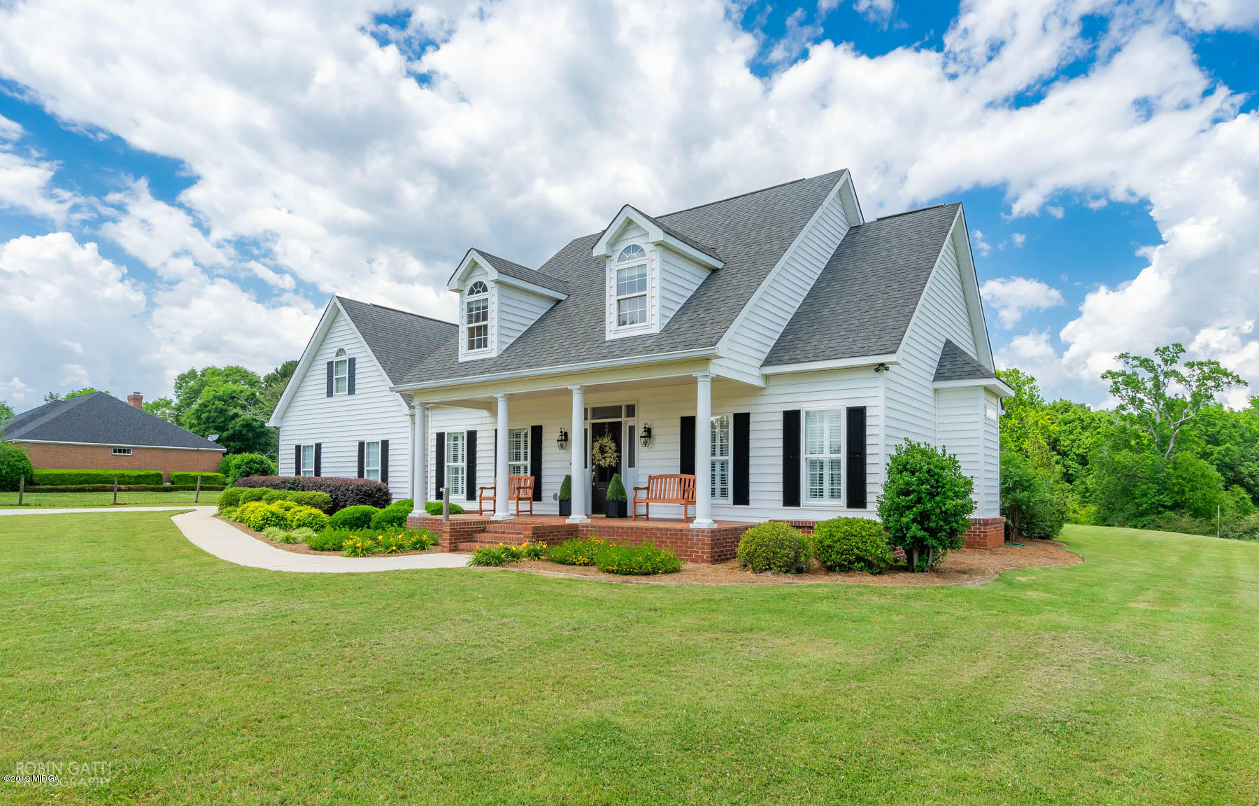 9801 Lower Thomaston Road Macon, GA 31220 - Photo 2 of 40 a front view of a house with a garden and plants