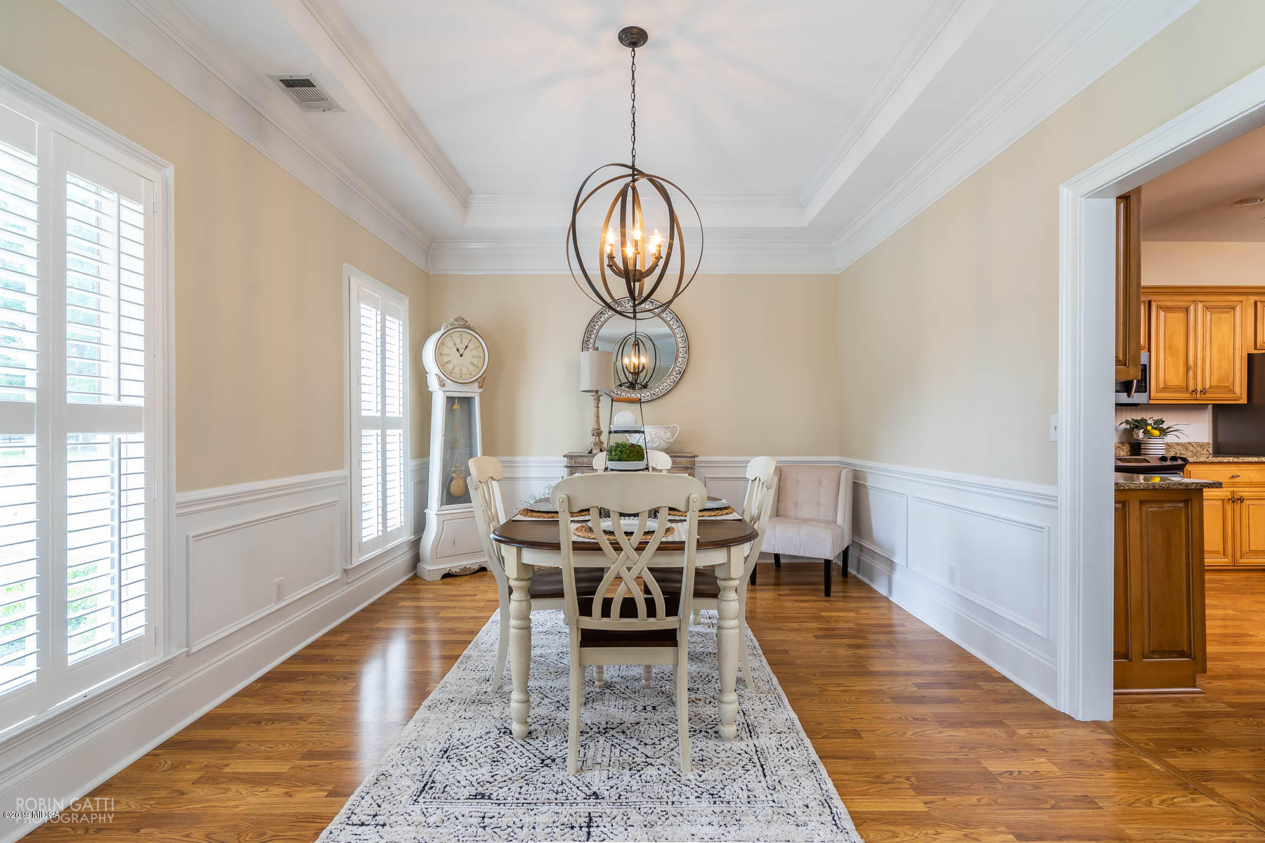 9801 Lower Thomaston Road Macon, GA 31220 - Photo 14 of 40 a view of a dining room with furniture a chandelier and wooden floor