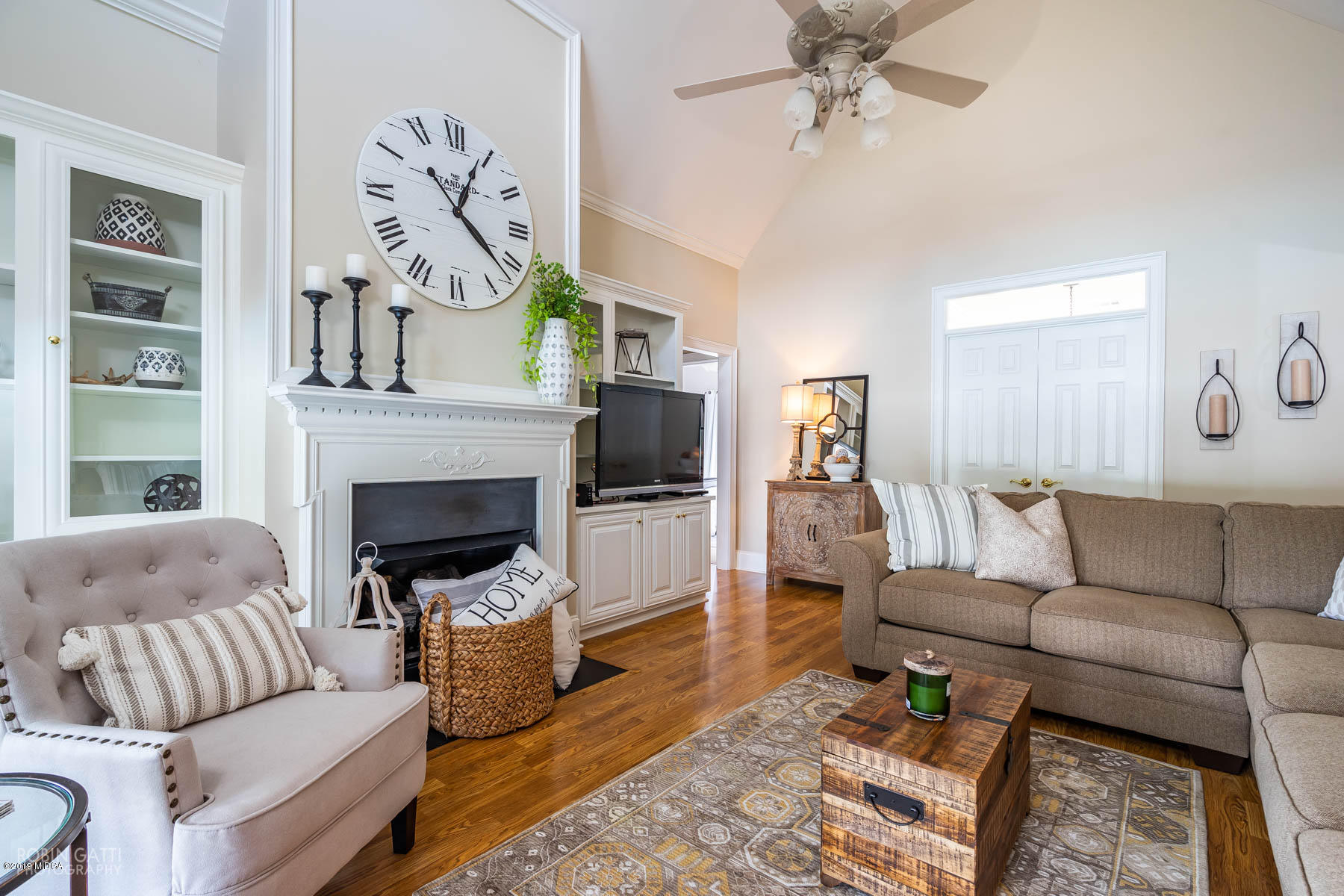 9801 Lower Thomaston Road Macon, GA 31220 - Photo 22 of 40 a living room with furniture a flat screen tv and a fireplace