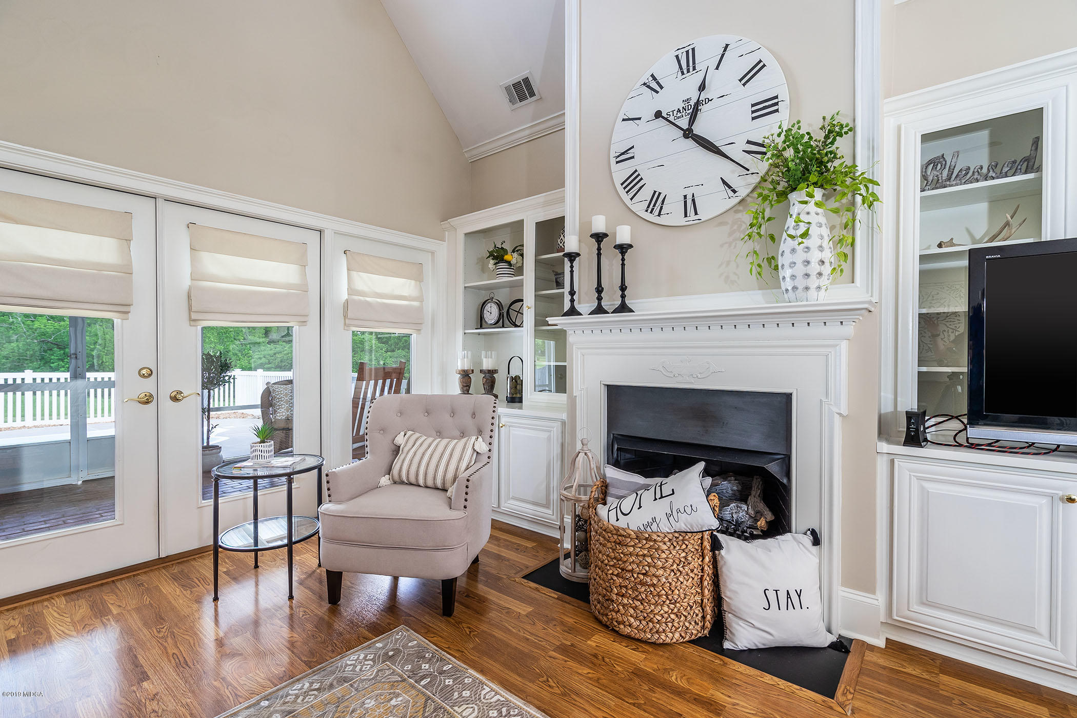 9801 Lower Thomaston Road Macon, GA 31220 - Photo 26 of 40 a living room with furniture a fireplace and a floor to ceiling window