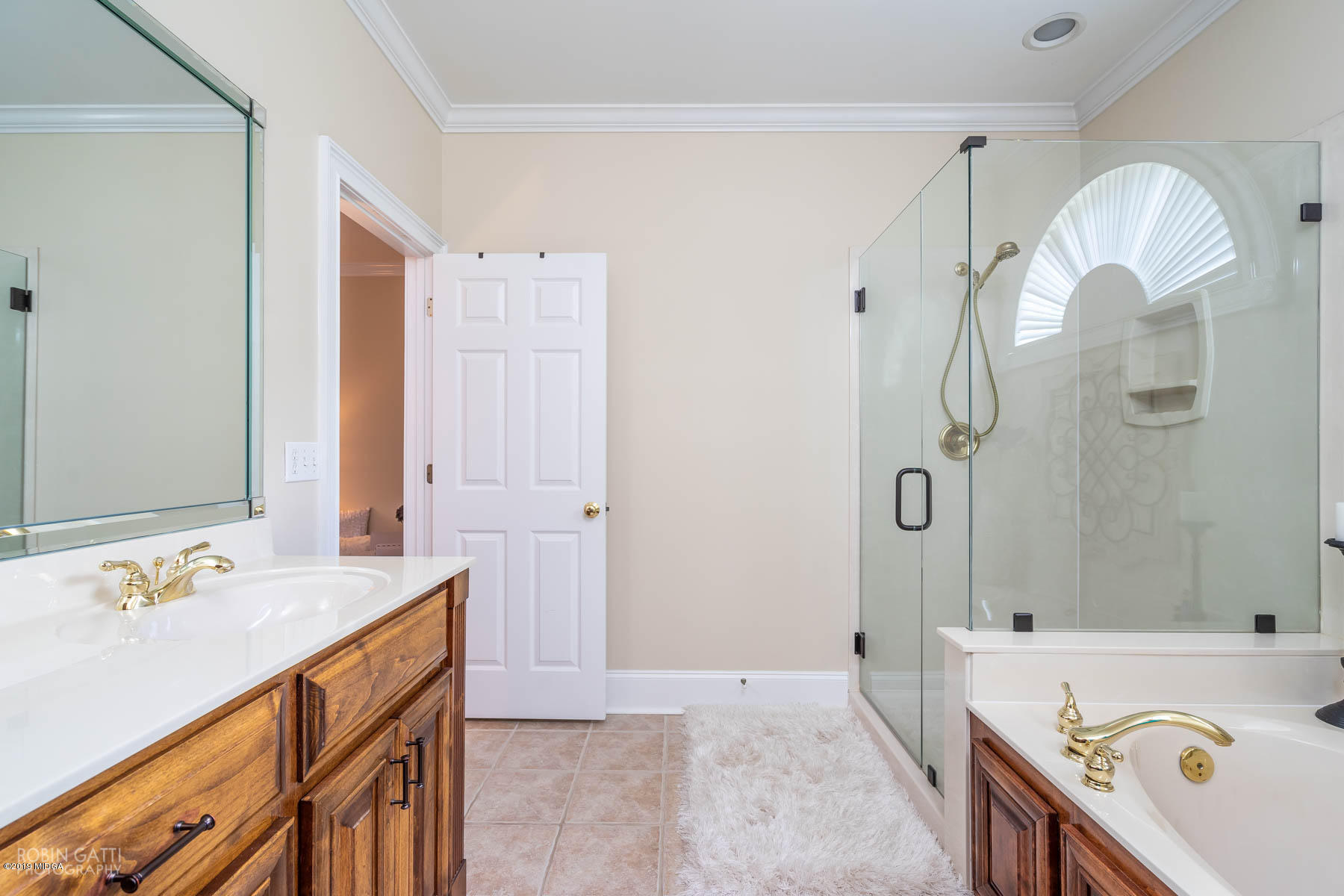 9801 Lower Thomaston Road Macon, GA 31220 - Photo 36 of 40 a bathroom with a sink a mirror a bathtub and a shower