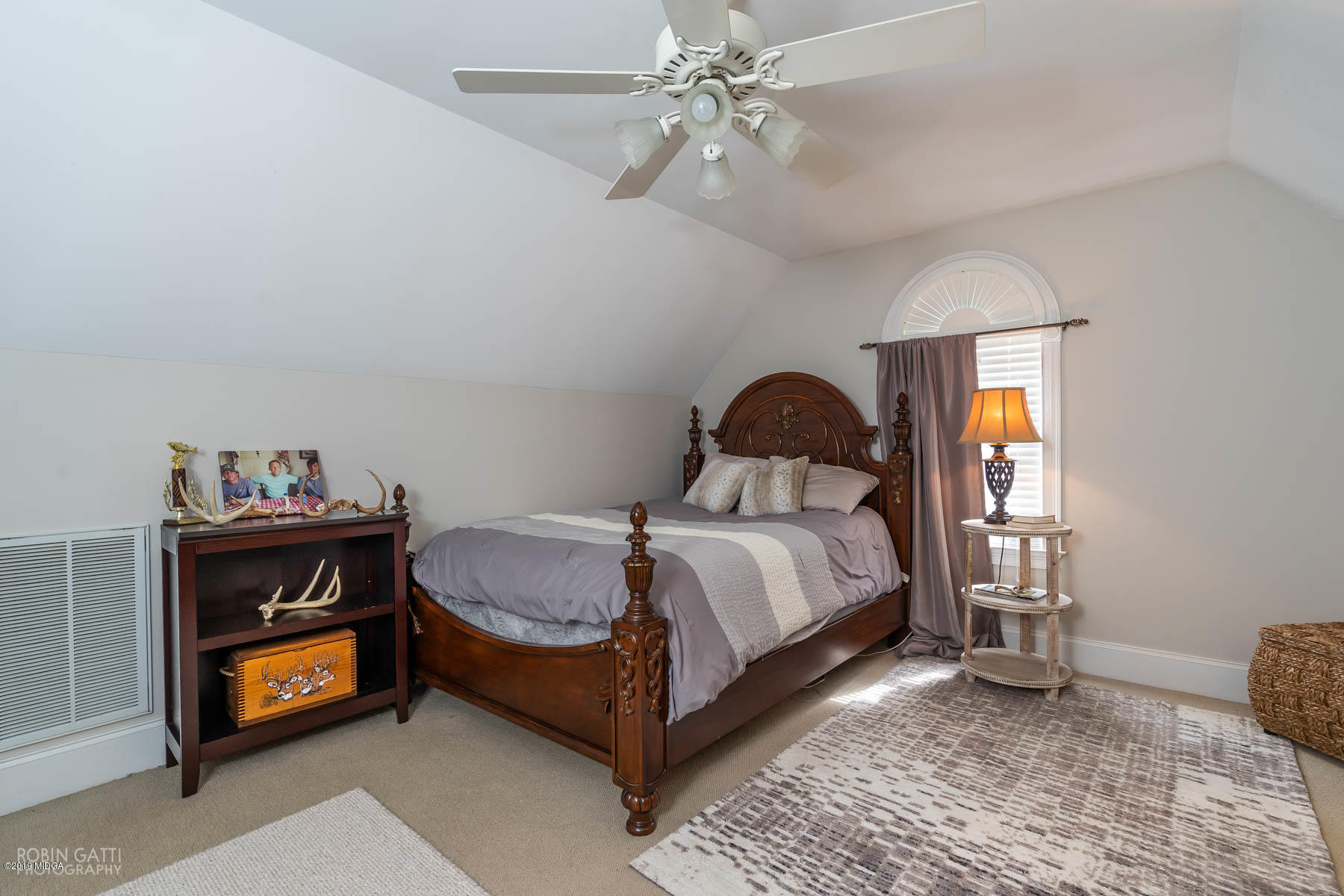 9801 Lower Thomaston Road Macon, GA 31220 - Photo 39 of 40 a bedroom with a bed and a chandelier