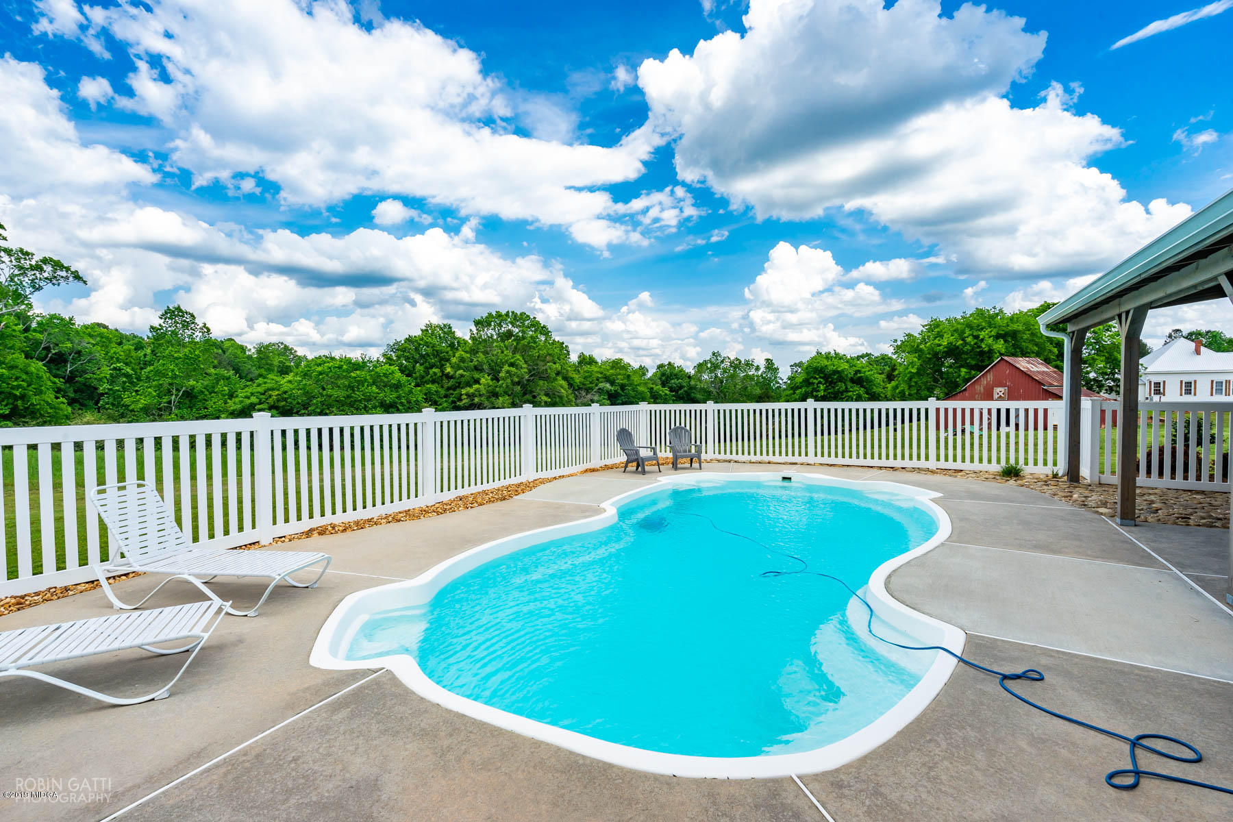 9801 Lower Thomaston Road Macon, GA 31220 - Photo 7 of 40 a view of a swimming pool with a lounge chair