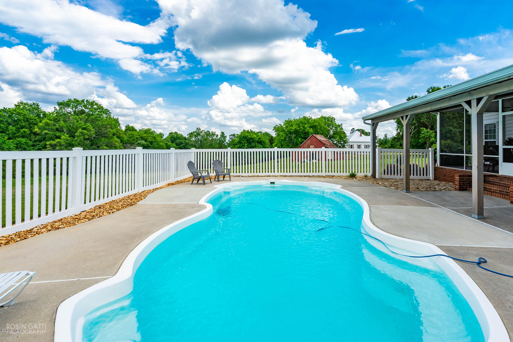 9801 Lower Thomaston Road Macon, GA 31220 - Photo 8 of 40 a view of a swimming pool with a patio and a yard