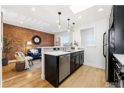 a kitchen with a sink cabinets and wooden floor