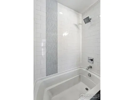 a bathroom with a tub shower and a sink