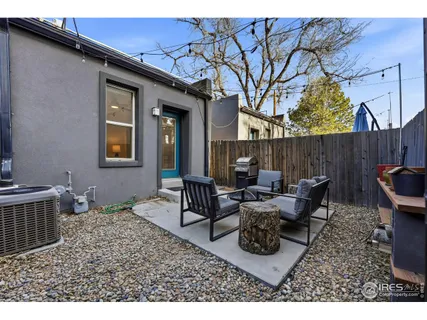 a backyard of a house with table and chairs