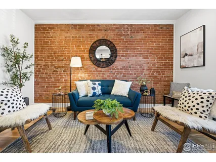 a outdoor living room with furniture and wall paintings