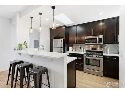 a kitchen with kitchen island a sink stainless steel appliances and cabinets