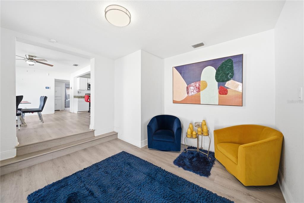 4988 Clarcona Ocoee Road Orlando, FL 32810 - Photo 11 of 48 a living room with furniture and a painting on the wall